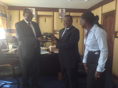 KTB Product Manager Fred Okeyo (left) hands a present to Bungoma county Governor Keneth Lusaka. Looking is county executive member in charge of tourism. KTB team was on a tourism familiarization tour of the county.