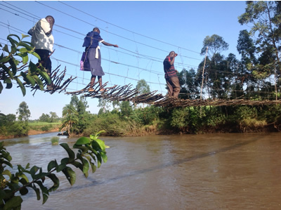 Balancing act: Residents cross over one of the locally made footbridge in Bungoma. 