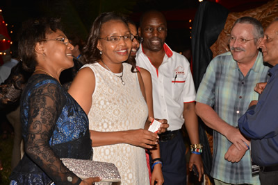 Cabinet Secretary for East African Affairs Commerce and Tourism Phyllis Kandie accompanied by Kenya Tourism Board M.D. Muriithi Ndegwa shares a light moment with tourists at a cocktail before the launch of the 5th edition of Magical Kenya Travel Expo